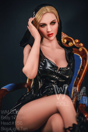 Sex Doll figure of a woman in a black outfit sitting on an ornate chair.